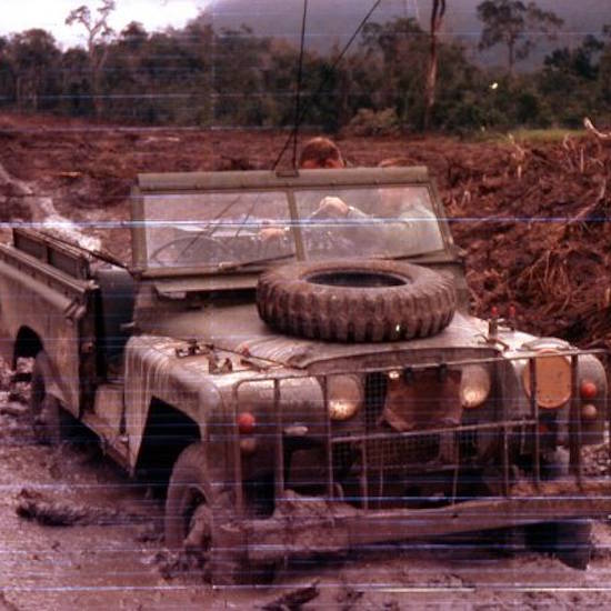 A Series 2 Land Rover in Vietnam bogged in mud