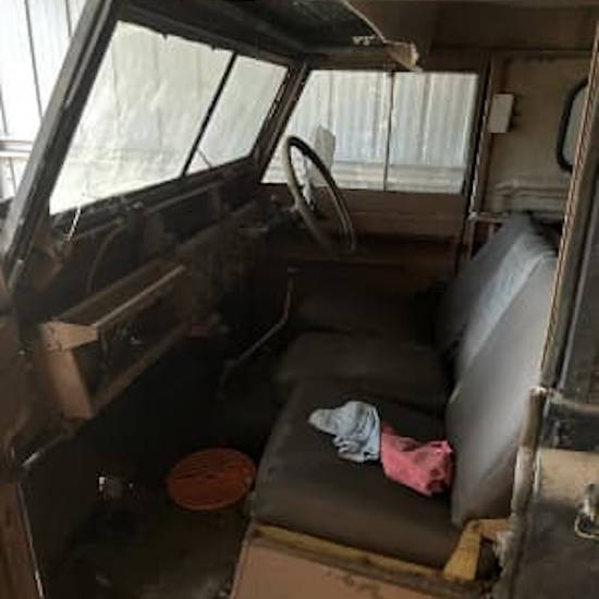 The dusty interior of a 1960 Series 2 Land Rover barn find that has been sitting in a field for 15 years