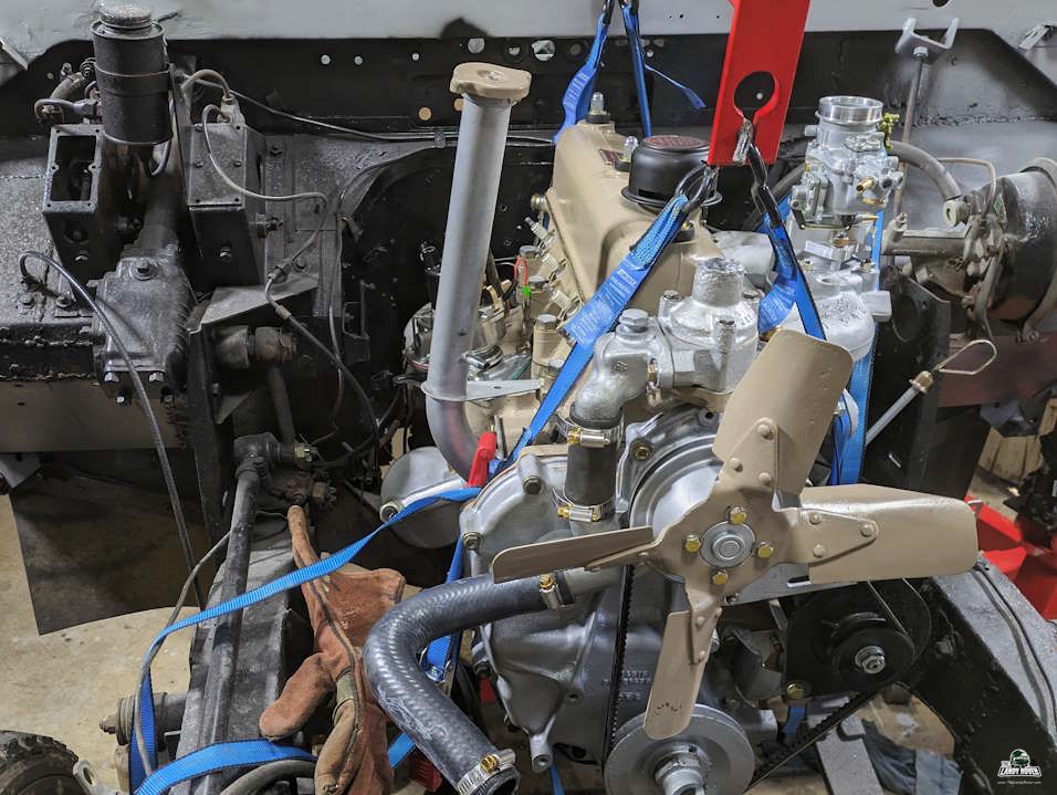 Holden 202 motor hanging from chains track panel